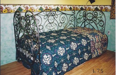 Wrought iron canopy bed with ornate scrollwork