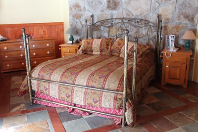 Wrought iron bed with scrollwork headboard