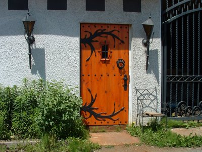Wooden door with decorative wrought iron hardware