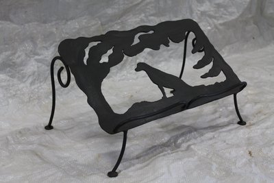 Wrought iron log holder with wolf silhouette