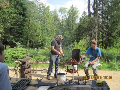 Outdoor blacksmithing demonstration at a festival