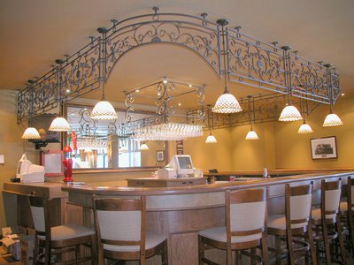 Decorative wrought iron arch over commercial bar