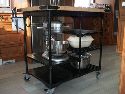 Rolling wrought iron kitchen island with butcher block top