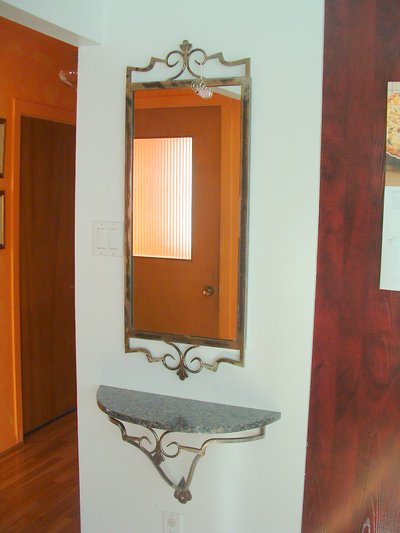 Wrought iron entryway mirror and shelf with scrollwork