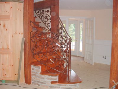 Wrought iron entry gate with stone pillars and lanterns