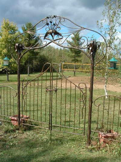 Wrought iron garden arbor gate with scrollwork