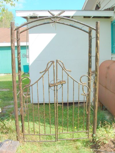 Wrought iron garden gate with arch