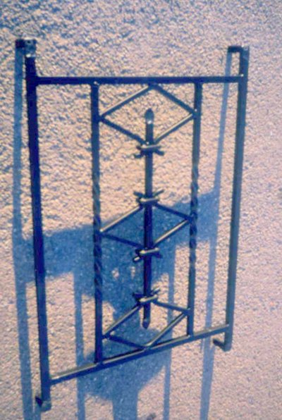 Wrought iron grille with geometric patterns