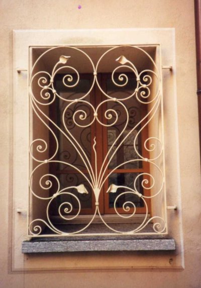 Wrought iron window grille with heart-shaped scrollwork