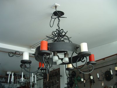 Wrought iron chandelier with candle holders and scrollwork