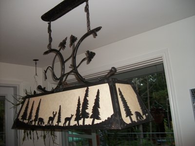 Large wrought iron chandelier with deer and pine trees
