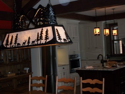 Wrought iron chandelier with forest scene in kitchen