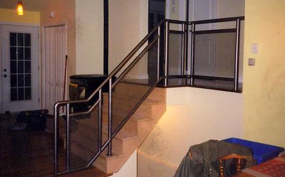 Modern metal staircase railing with mesh panels