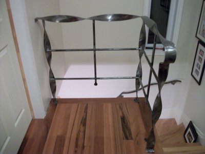 Modern staircase railing with twisted bars, top view