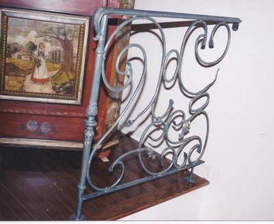 Wrought iron newel post with decorative scrollwork