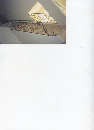 Wrought iron staircase railing with scrollwork